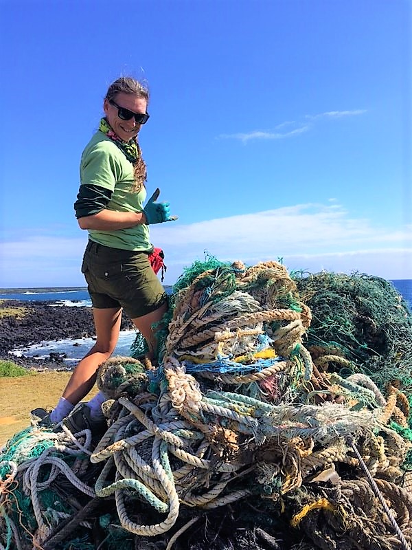 Mattie Mae of Upcycle Hawaii standing next to a pile of ghost nets that have been removed from the shores of the Big Island. 
Upcycle Hawaii uses ghost nets to create upcycled melted marine debris products. 