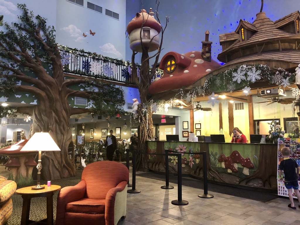 Enchanted forest front lobby with mushroom roofs and large trees at Zehnder's Splash Village.