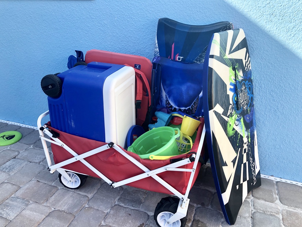 Wagon filled with beach toys and beach necessities. 