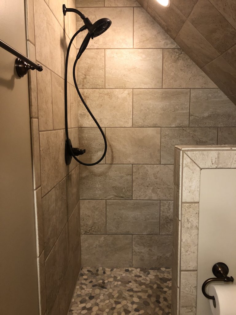 Master en suite shower with stone mosaic tile.