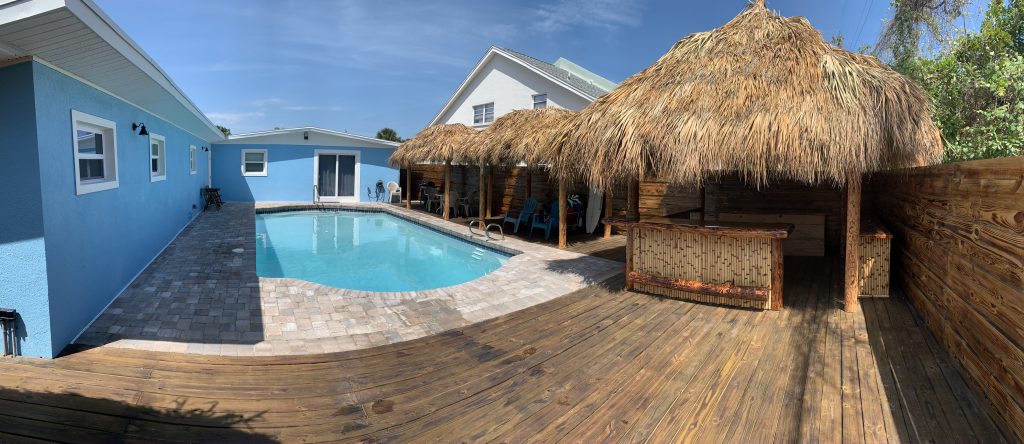 Backyard pool and tiki huts.