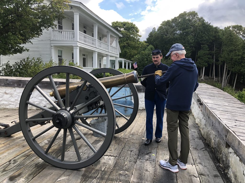 Fort Mackinac History - A soldier  giving instructions for how to fire the cannon. 