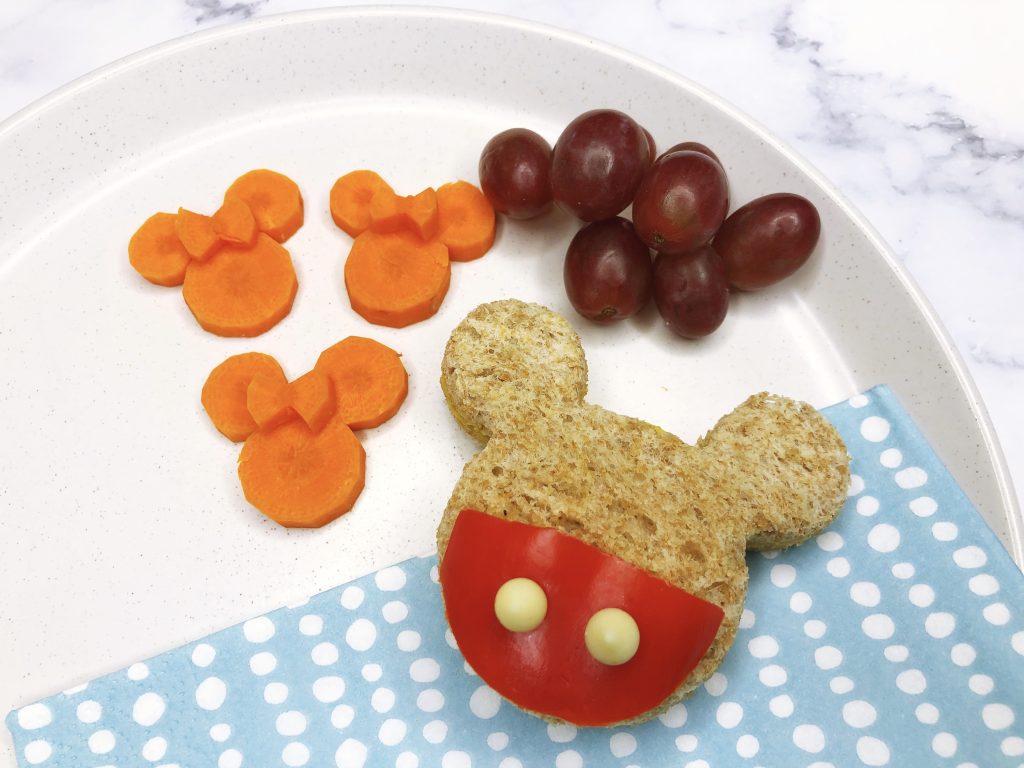 Mickey Mouse shaped sandwich with Minnie shaped carrots and grapes. - Can I bring food into Disney?