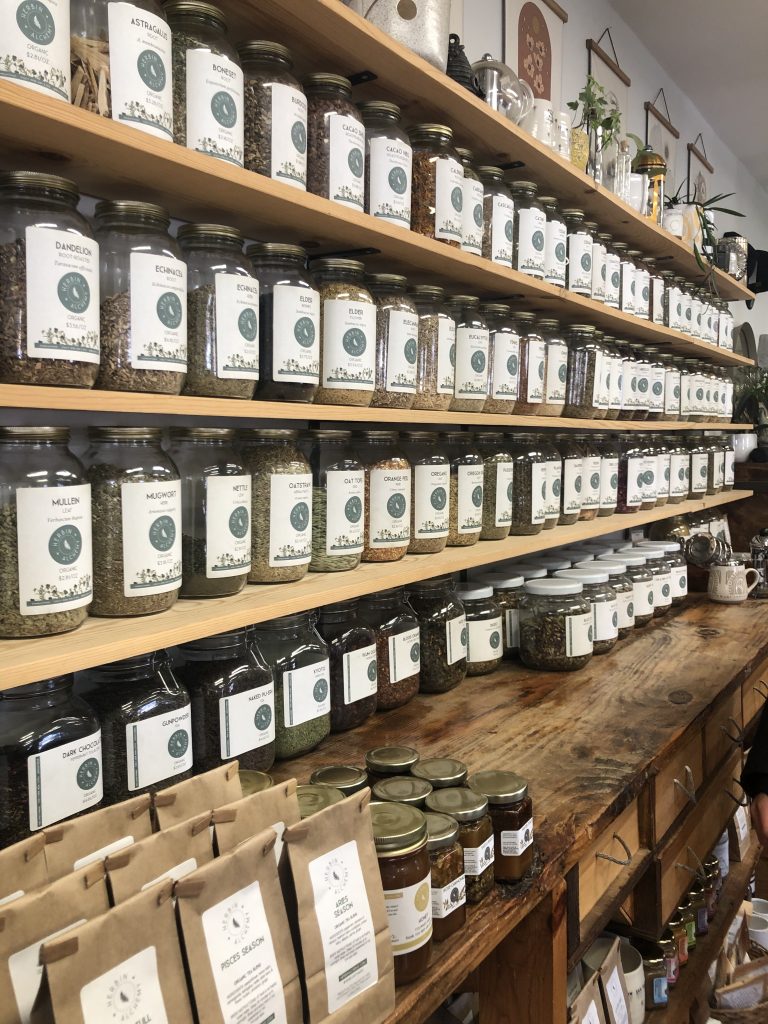 Wall of loose-leaf tea in jars inside the Meadowsweet Gifts and Wellness Store - Morrison, CO